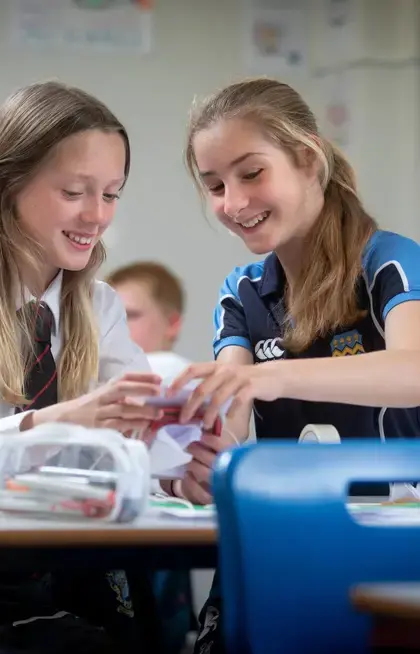 Two Pocklington School pupils helping each other in class