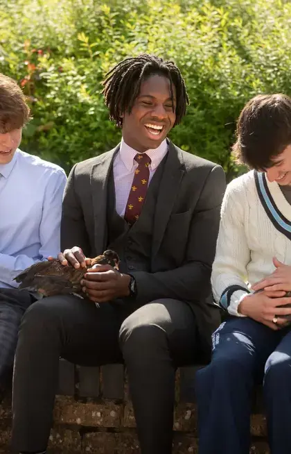 Three Pocklington School pupils holding chickens and ducks