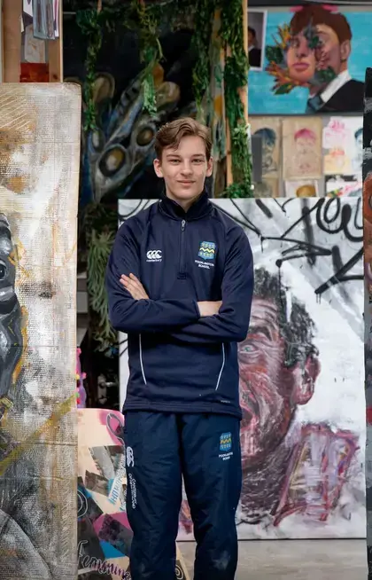 Pocklington School pupil standing in front of A level artwork