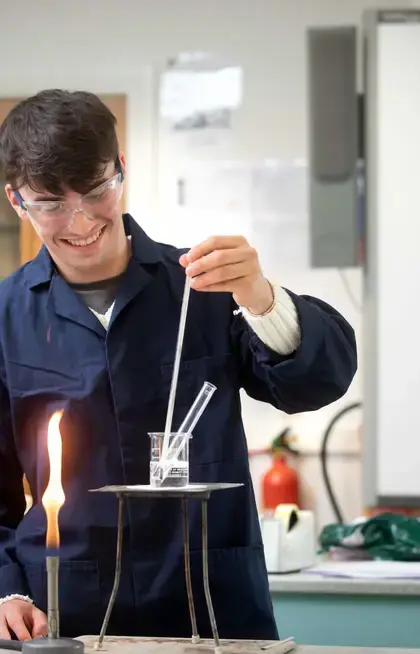 Pocklington School Sixth Former using a bunsen burner in Chemistry